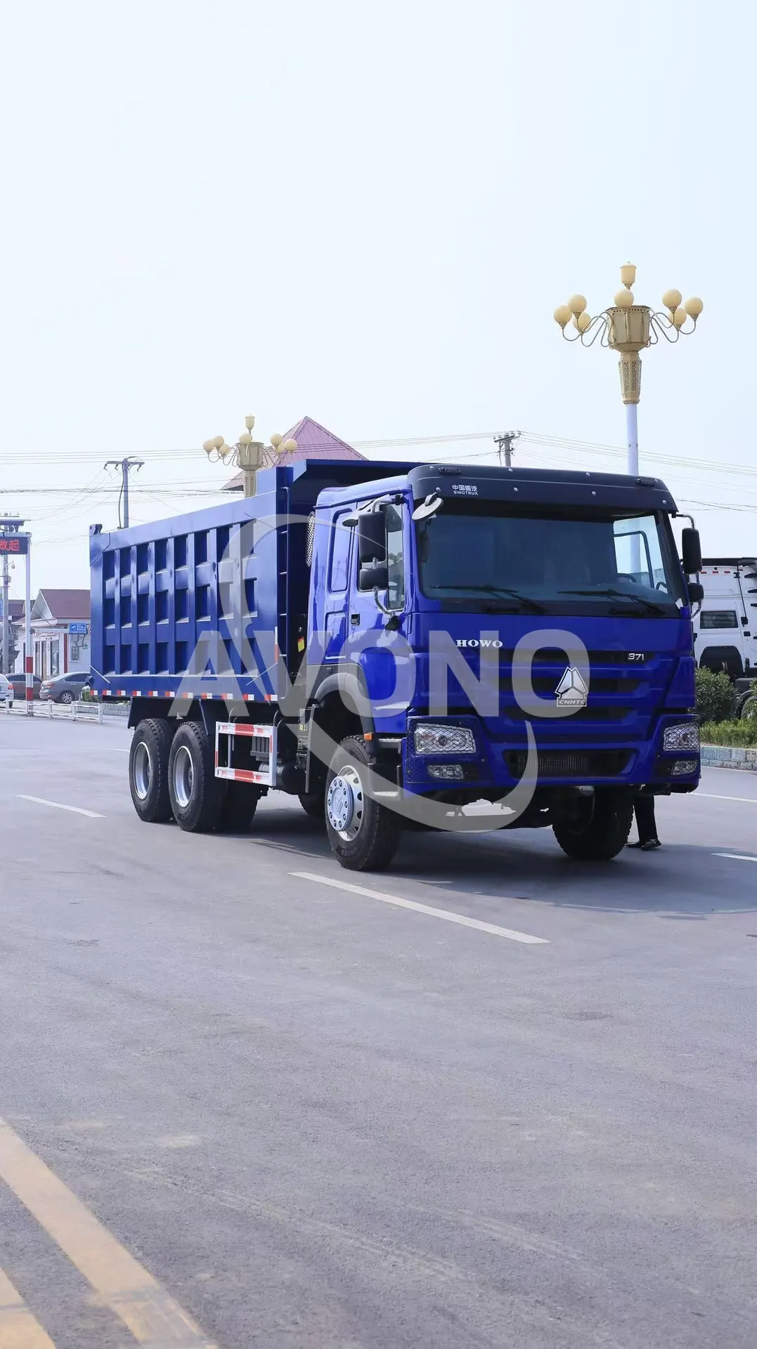 Blue refurbished HOWO dump truck on the road during a pre-delivery check